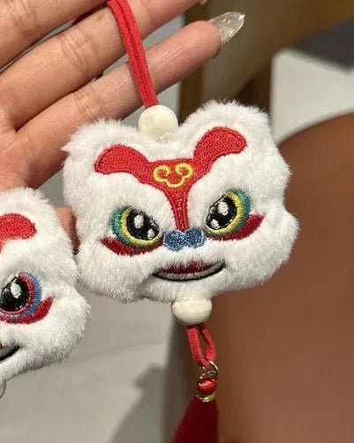 Chinese style blue and yellow plush lion keychain ornament with star stone decoration and cartoon styling