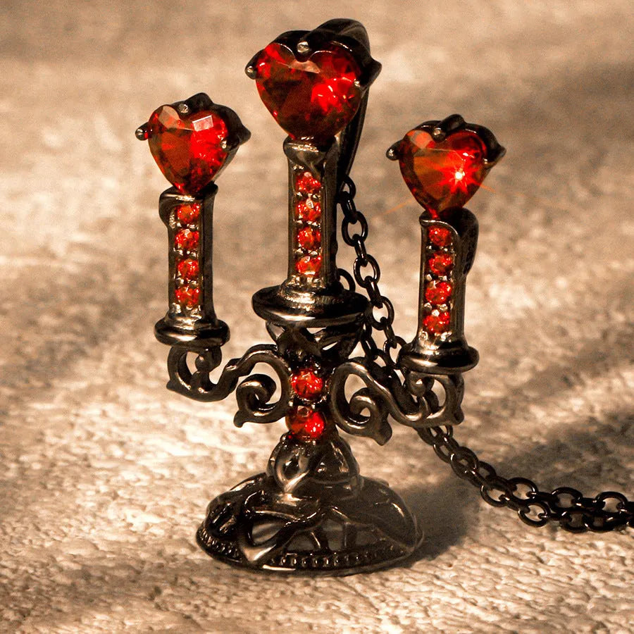 Zinc alloy gothic necklace with hollow candlestick pendant and cross chain on a dark background.