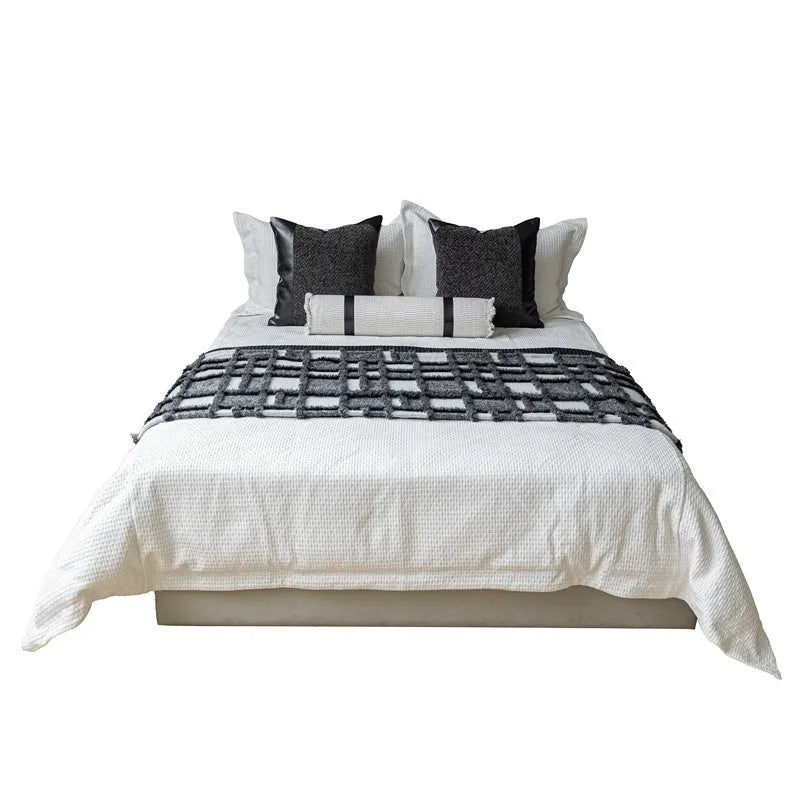 Grey and white plaid polyester bed runner nap blanket set with pillow on a bed.