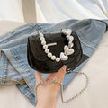 Silver laser pearl tote saddle mini crossbody bag for women on a model