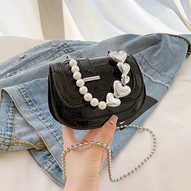 Silver laser pearl tote saddle mini crossbody bag for women on a model