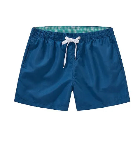 Men's straight leg beach shorts in polyester available in multiple colours and plus sizes.