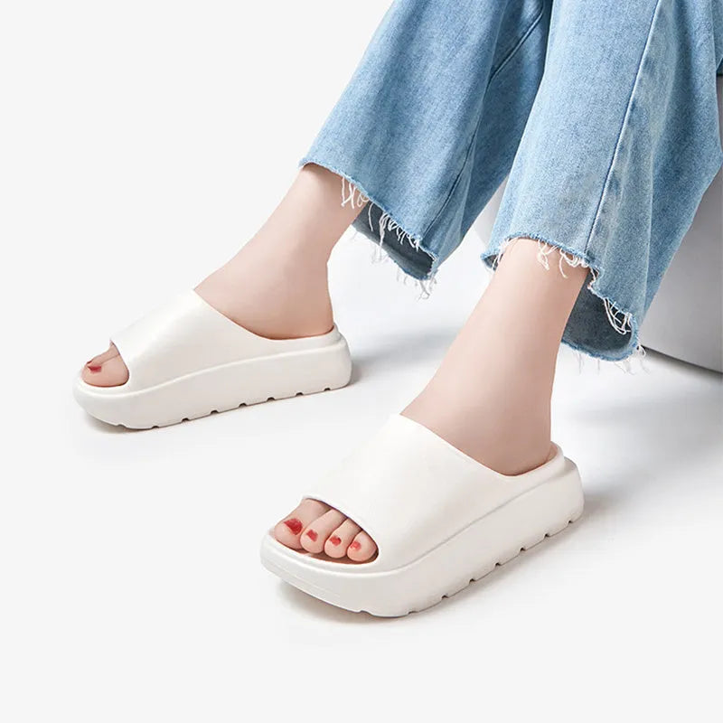 Women's beige thick-soled EVA slippers with a 5.5cm platform, shown from the side.