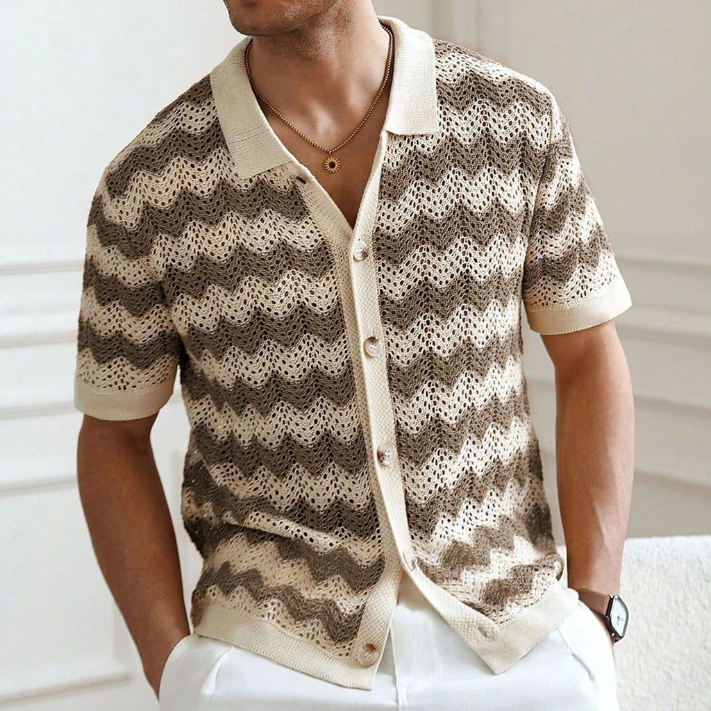 Short-sleeved yellow corrugated knit sweater with flocking detail on a hanger.