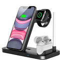 Black folding 4-in-1 wireless charger standing vertically, charging an iPhone and an Apple Pencil.