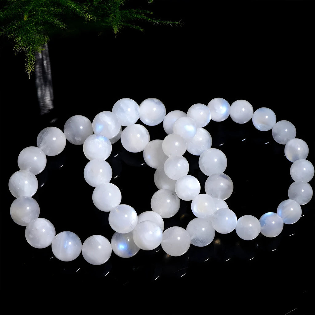 Natural blue moonlight round bead moonstone bracelet with geometric shape on a wrist.