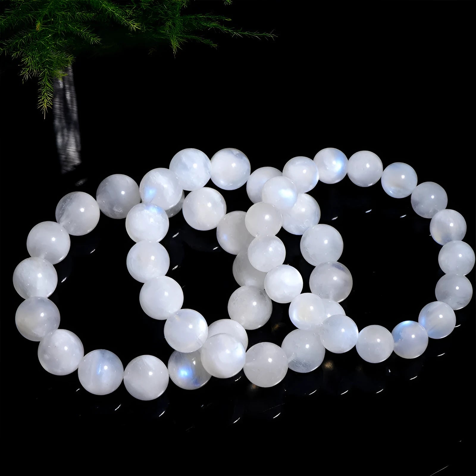 Natural blue moonlight round bead moonstone bracelet with geometric shape on a wrist.