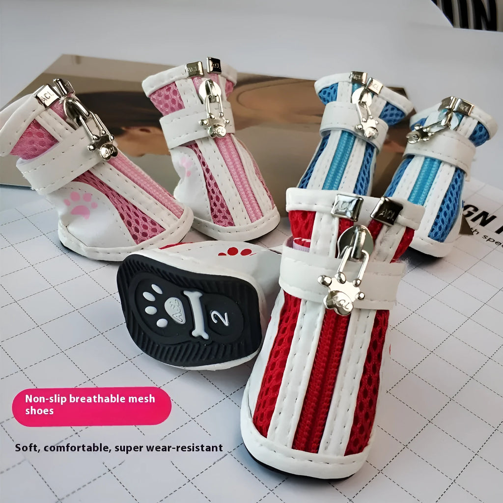Set of four blue cloth dog shoes with zippers for small breed pets on a white background