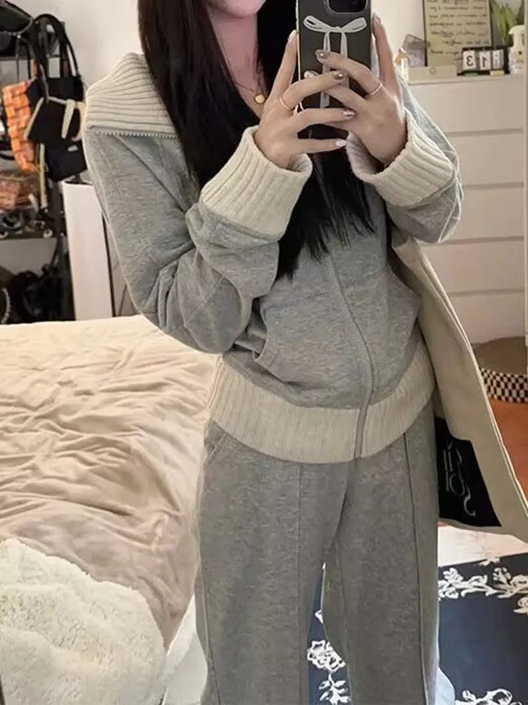 Women's light gray polyester two-piece set consisting of a pocket coat and wide leg trousers, shown flat lay view.