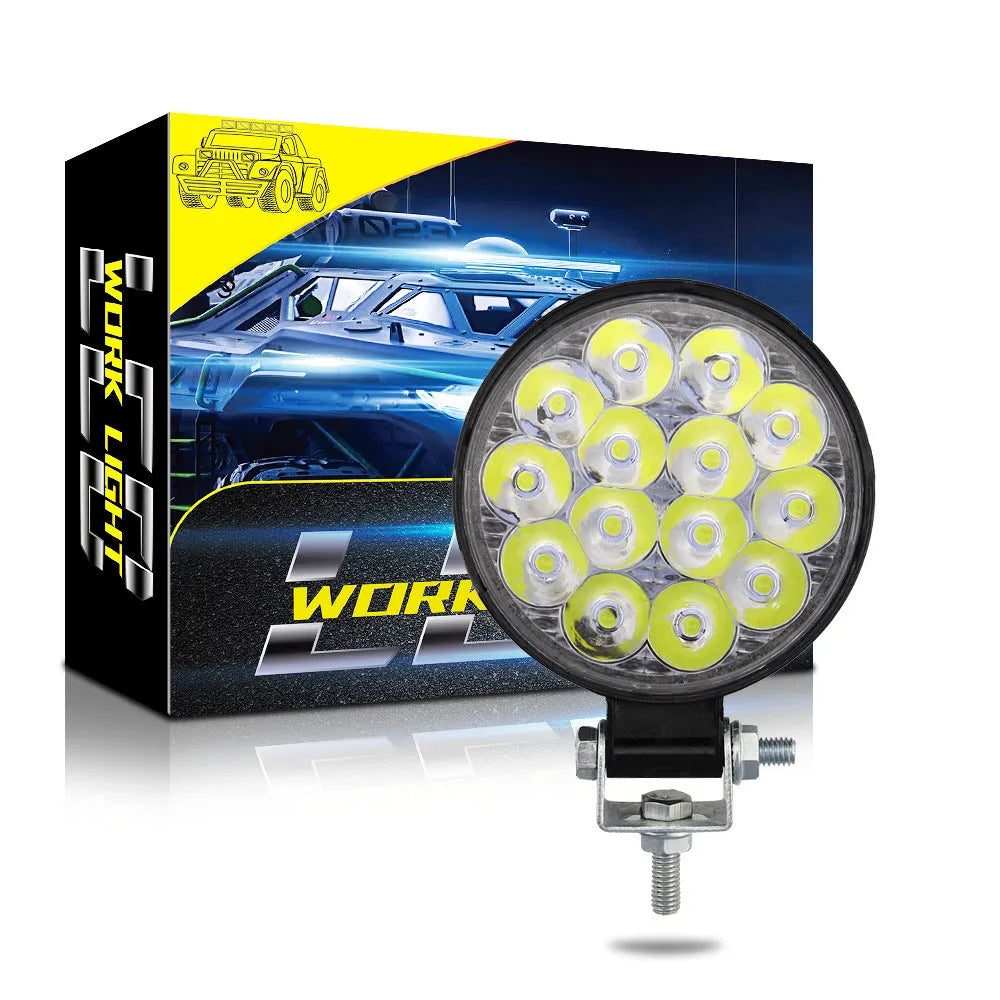 Round mini aluminium LED work light showing white light beam, suitable for vehicle mounting.