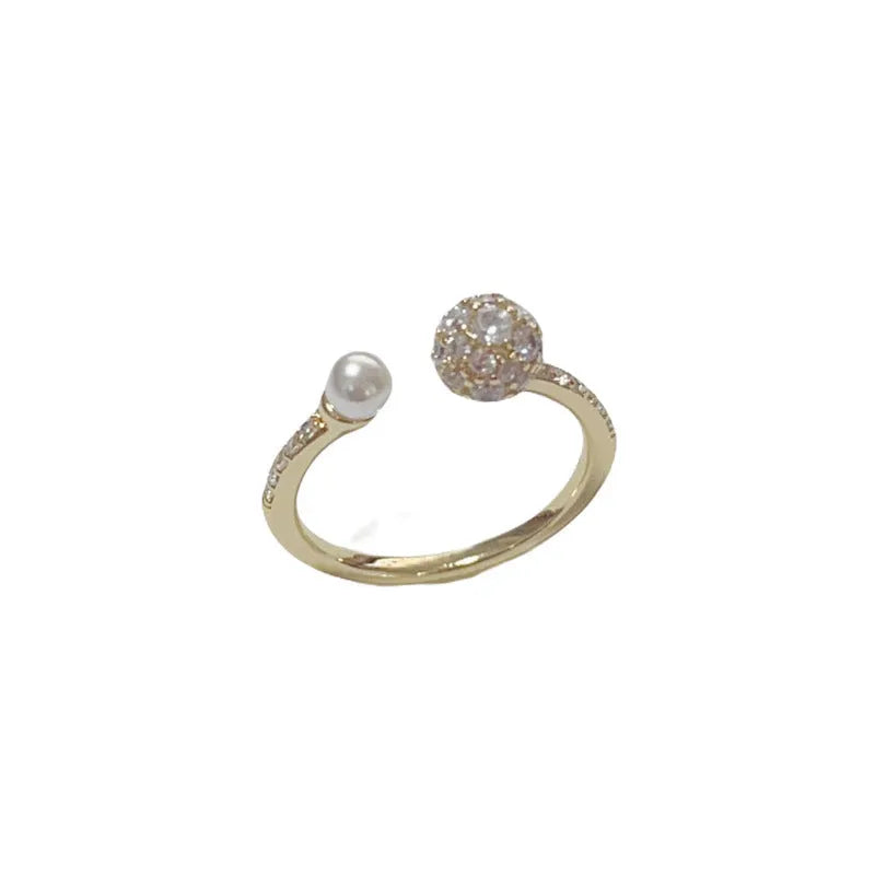 Open-end pearl ring with round zircon stones in geometric design with gold plating