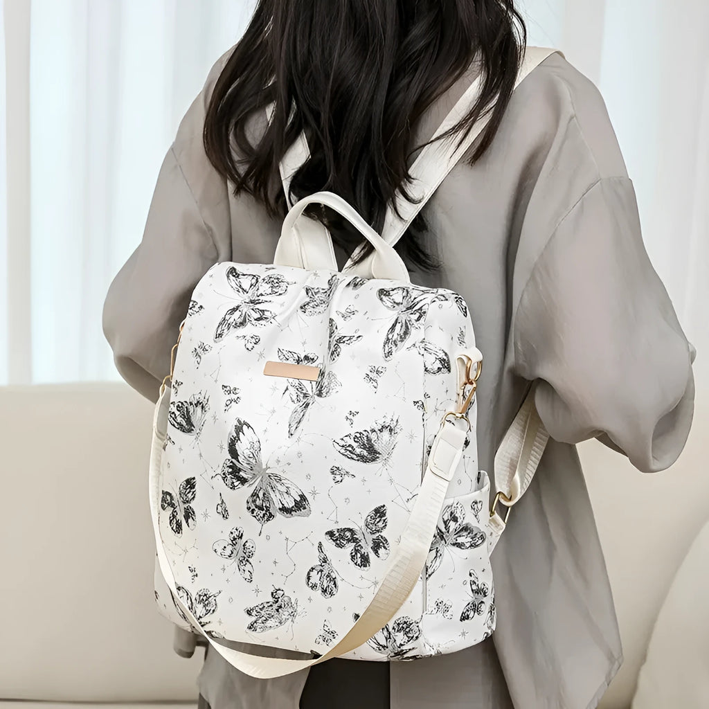 Butterfly print backpack with sewing line detail shown in multiple colour options