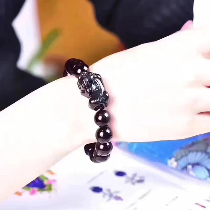 Natural ice colour eye obsidian crystal bead bracelet with spherical beads on wrist.
