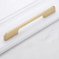 Gold coloured aluminium T-shaped single hole cabinet door handle on white background