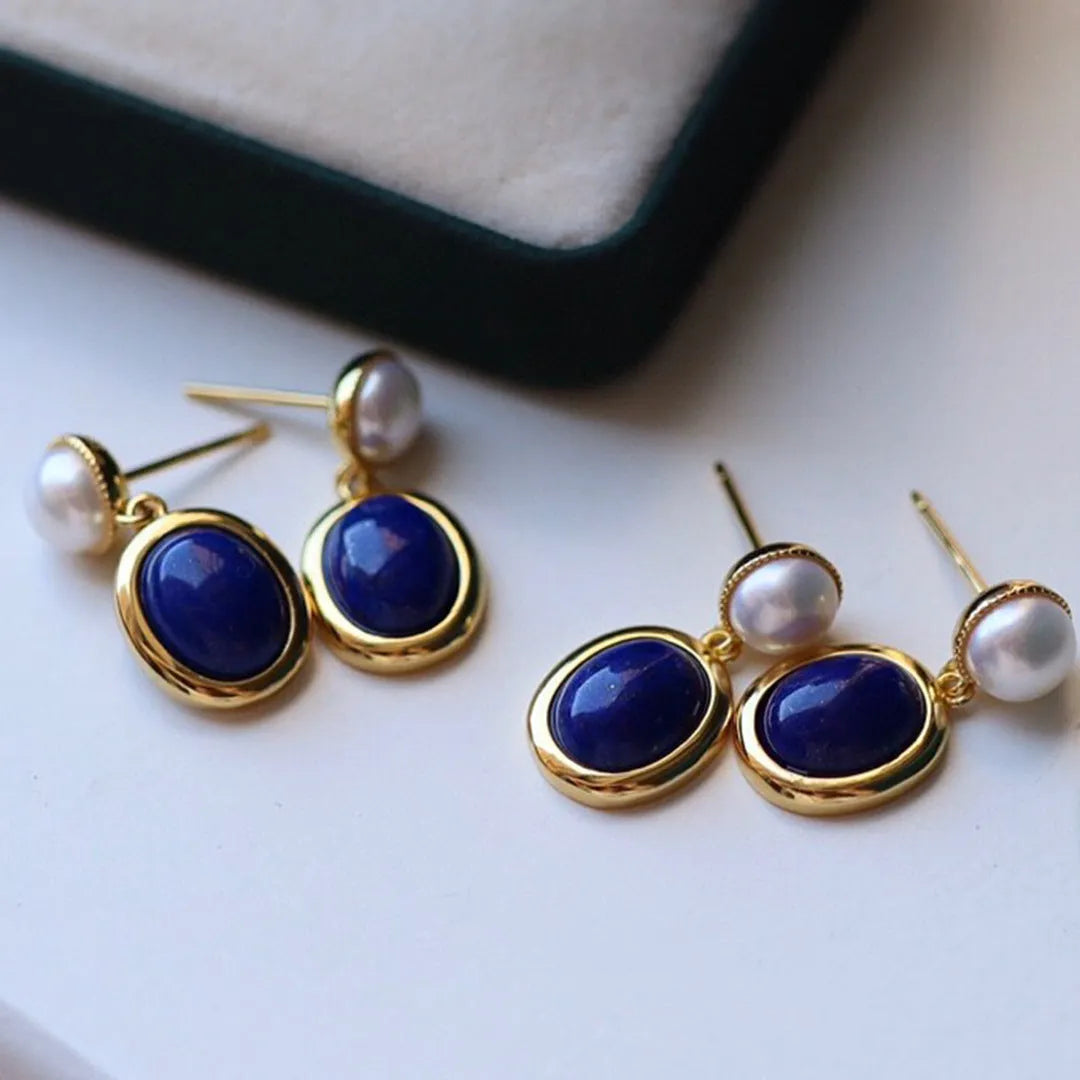 A pair of sterling silver earrings with deep blue lapis lazuli pearls and simple auspicious patterns.