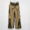 Retro high waist tooling jeans in dark khaki leopard print with contrast stitching and straight leg.