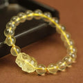 Yellow leather bracelet with artificial crystal beads and a Pi Xiu charm in simple Chinese style.