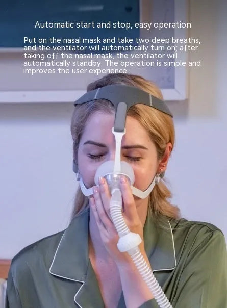 Yunzhongfei dark blue portable anti-snoring ventilator with nose mask and breathing pipeline on a table