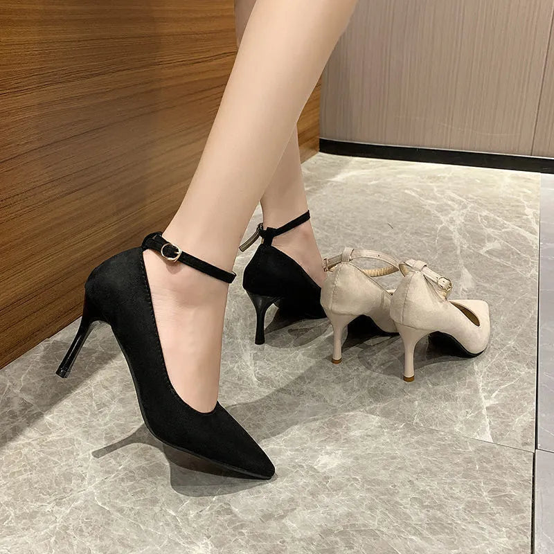 Women's black stiletto heels with buckle detail and skull pattern, showing 8cm heel