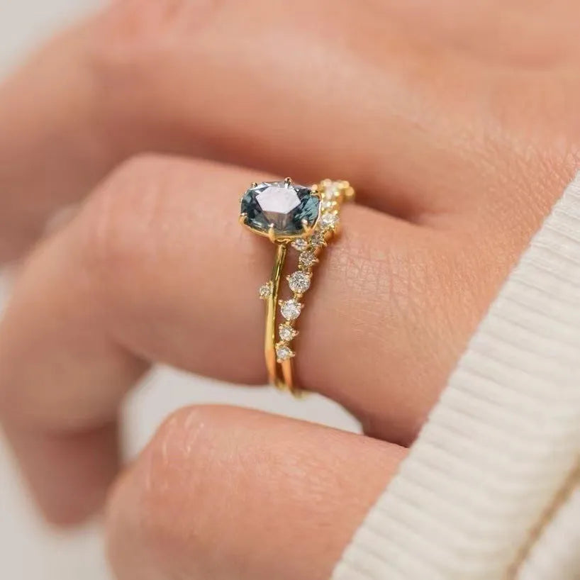 Gold plated women's ring with green zircon stones in floral design, shown as a pair for couple wear