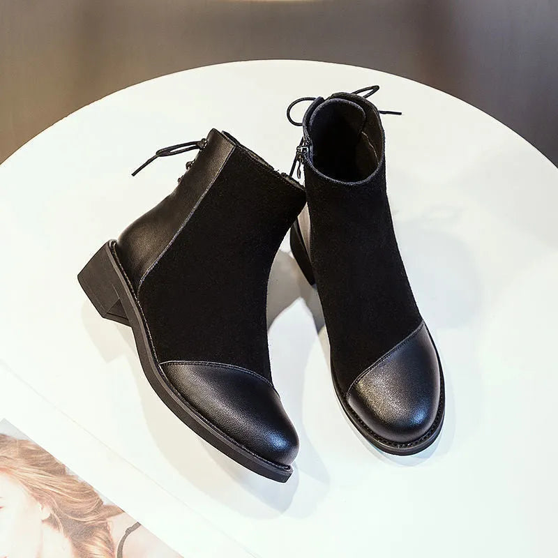 Black women's side-zip Martin boots with a round toe and short heel on a non-slip sole.