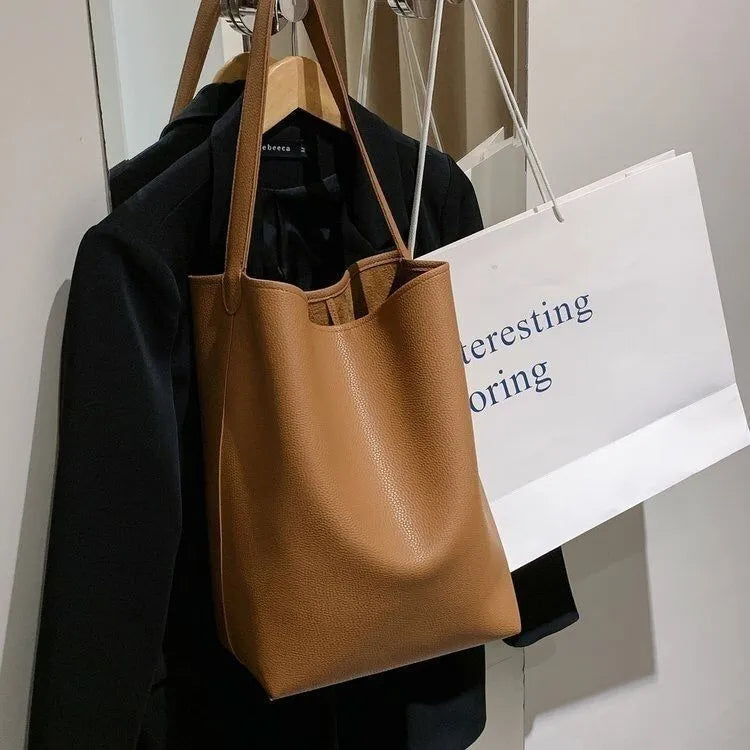 Casual PU shoulder bag for women with visible sewing thread detail in black