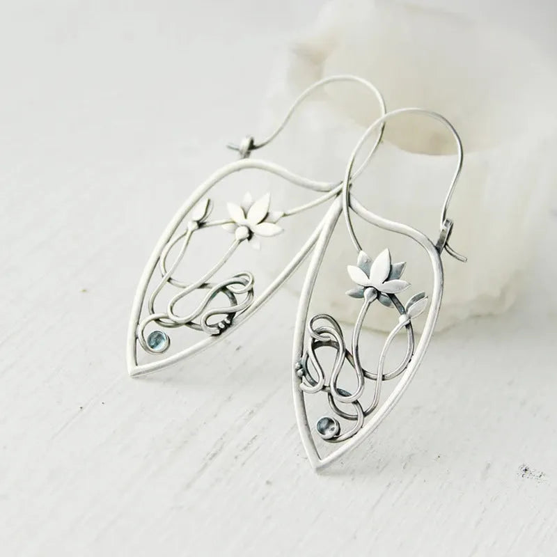 Silver lotus vine floral earrings with geometric elements and rhinestone accents