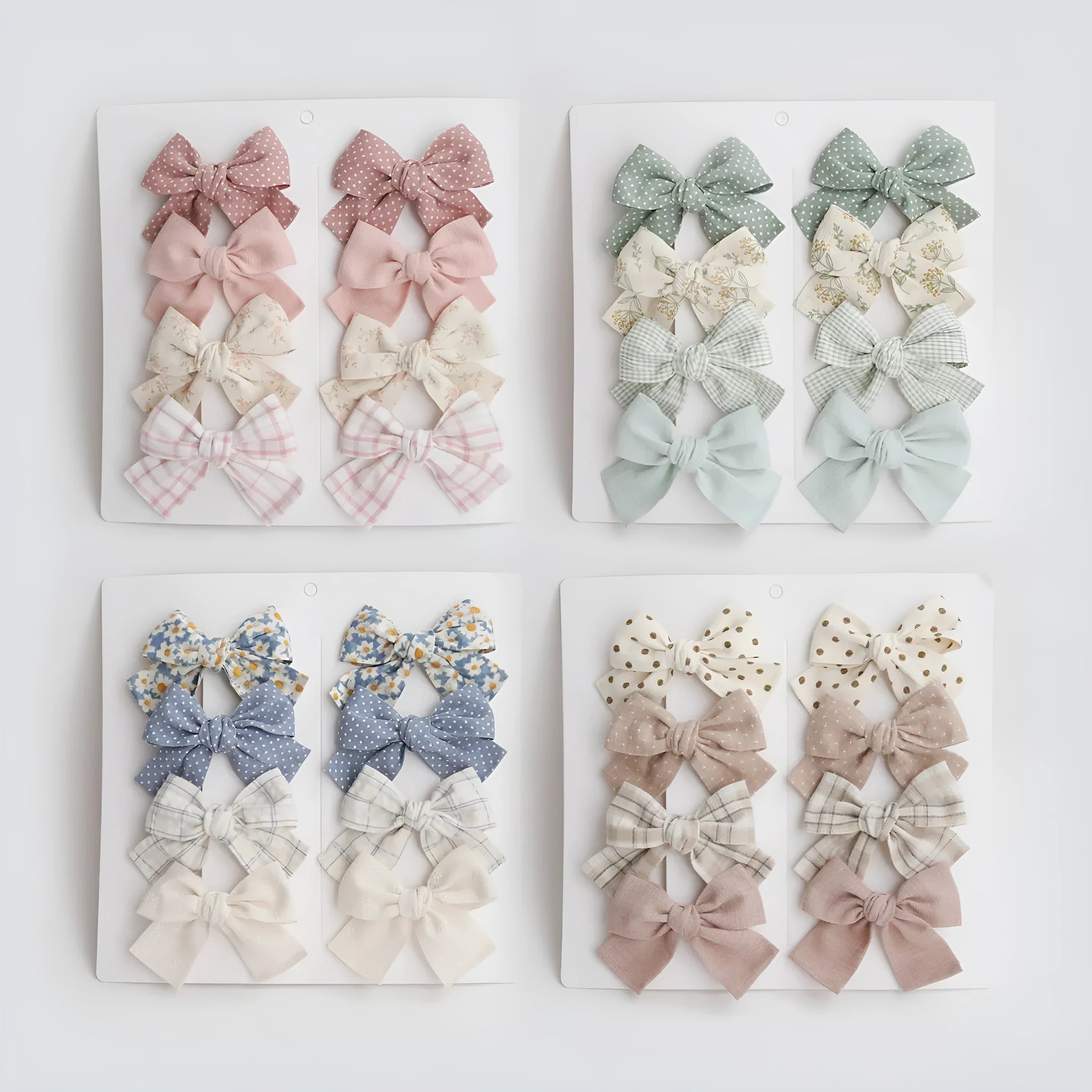 Set of fabric dovetail bow hair clips for children in various colours including beige, pink, and blue flowers.