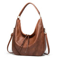 Women's soft PU leather tassel hollow shoulder bag in vertical square shape with sewing line details, black colour