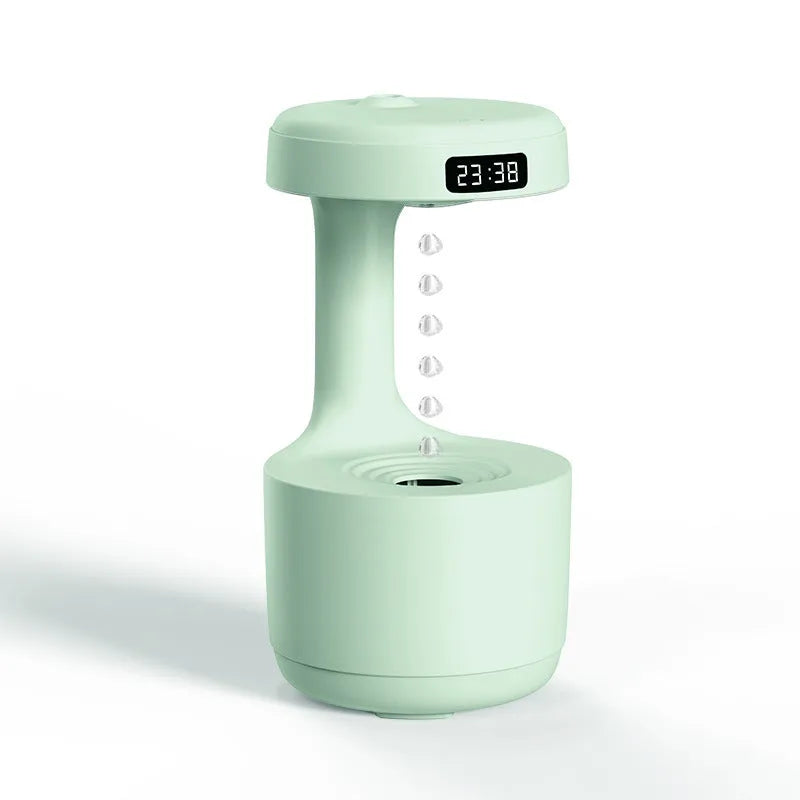 White anti-gravity air humidifier with levitating water drops and USB cable on a desk