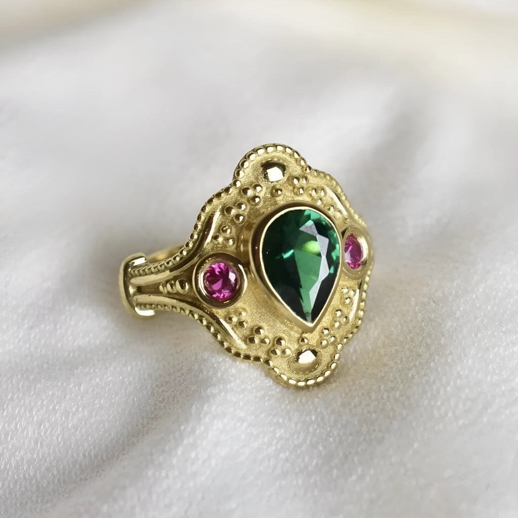 Gold-plated women's alloy ring with geometric shape and lvzuan colour on a white background.