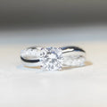 Silver moissanite ring with twisted arm geometric design and 1 carat centre stone