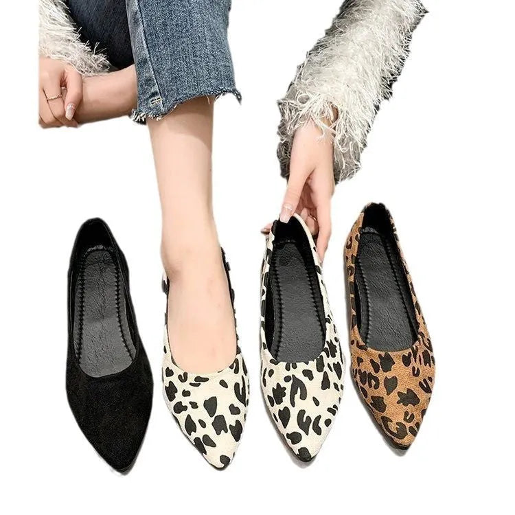 Women's flat pointed toe leopard print pumps with a low heel on a plain background.