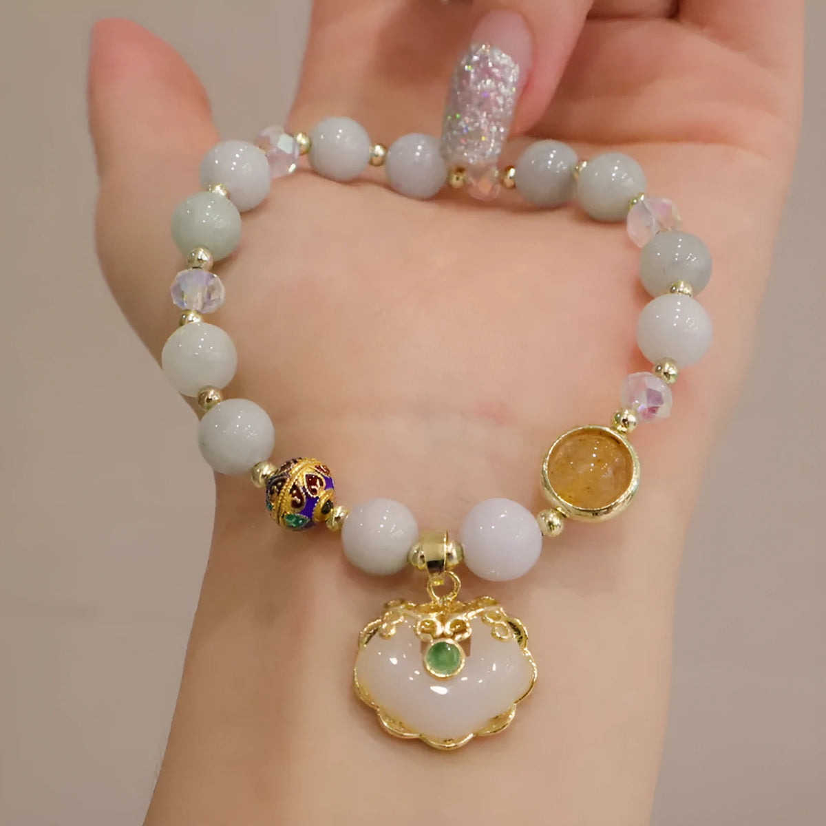 Geometric women's bracelet with ethnic metal decoration, available in Gray Jade or Strawberry Quartz.