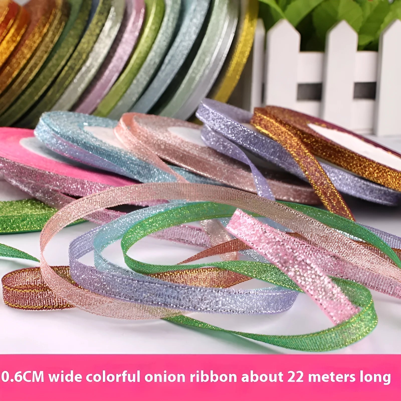 Roll of narrow 0.6cm wide polyester gift wrapping ribbon in an assorted colour, showing 22 metre length.