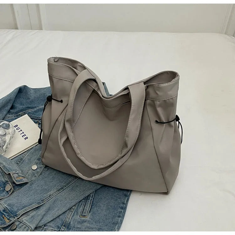 Soft Oxford cloth folding tote bag shown in multiple colours: black, brown, grey, and purple.