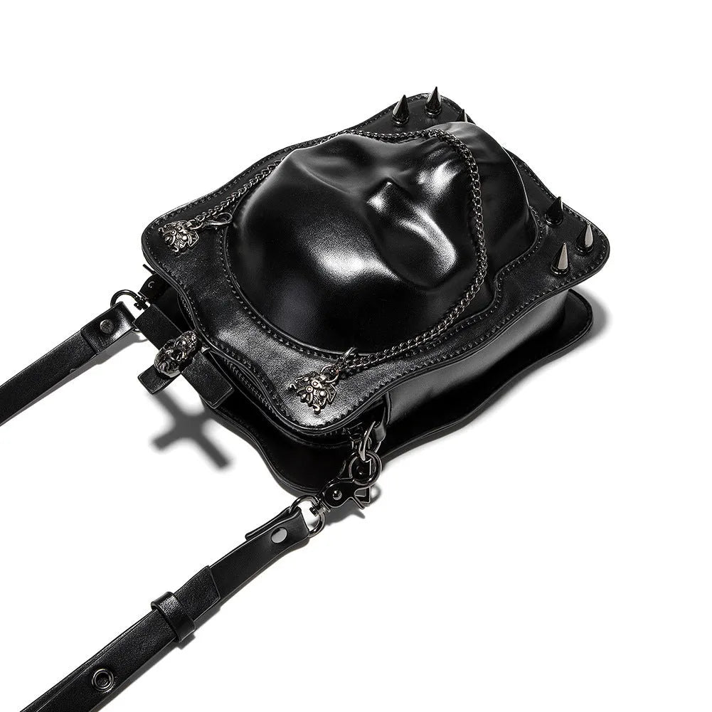 Black mini square shoulder bag with Gothic skull embossed design, chain strap, and zipper opening