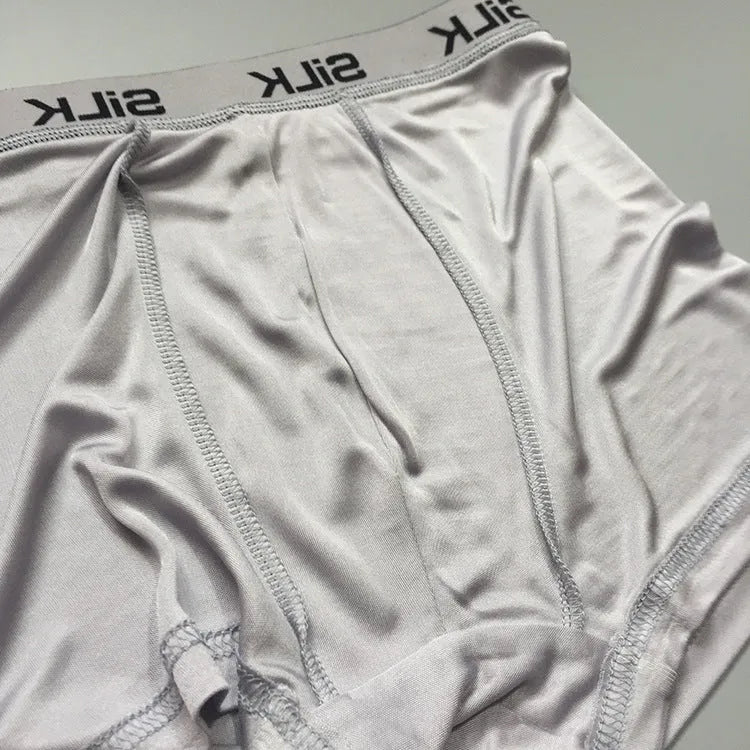 Men's loose fit silk shorts in navy blue, shown with mid waist design