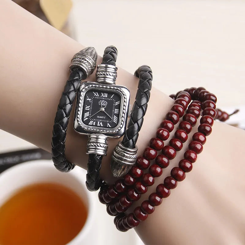 Snake bracelet quartz watch with leather strap and alloy buckle on a black background