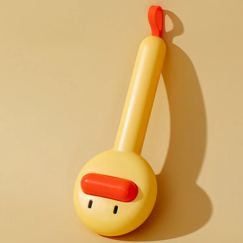 Small yellow duck-shaped pet grooming comb with open sections and needle teeth