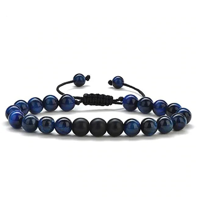 Matte black agate couple bracelets with geometric beads on wrist.