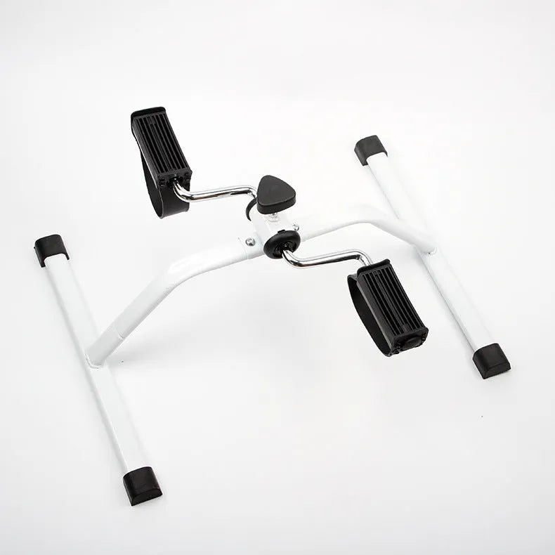 White mini exercise bike with non-slip pedals and monitor on rubber feet