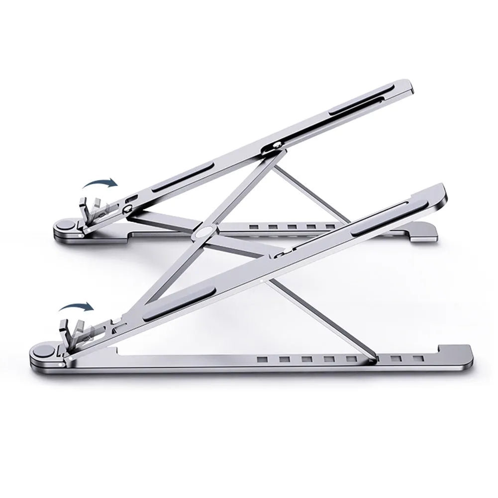 A folded deep grey aluminium laptop stand next to an open silver laptop on a desk.