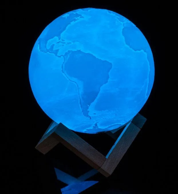 3D printed white moon lamp with detailed craters on a wooden stand, showing touch ring at base