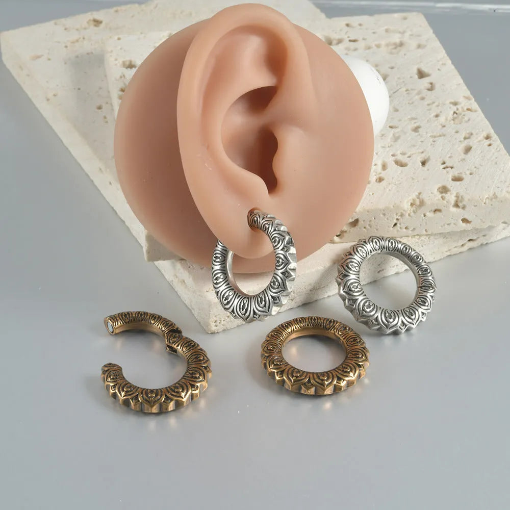 Large geometric dragon earrings with antique silver finish and hollow-out design on white background