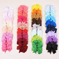 Assorted colourful 3-inch grosgrain ribbon pinwheel hair bows with alligator clips for toddlers.