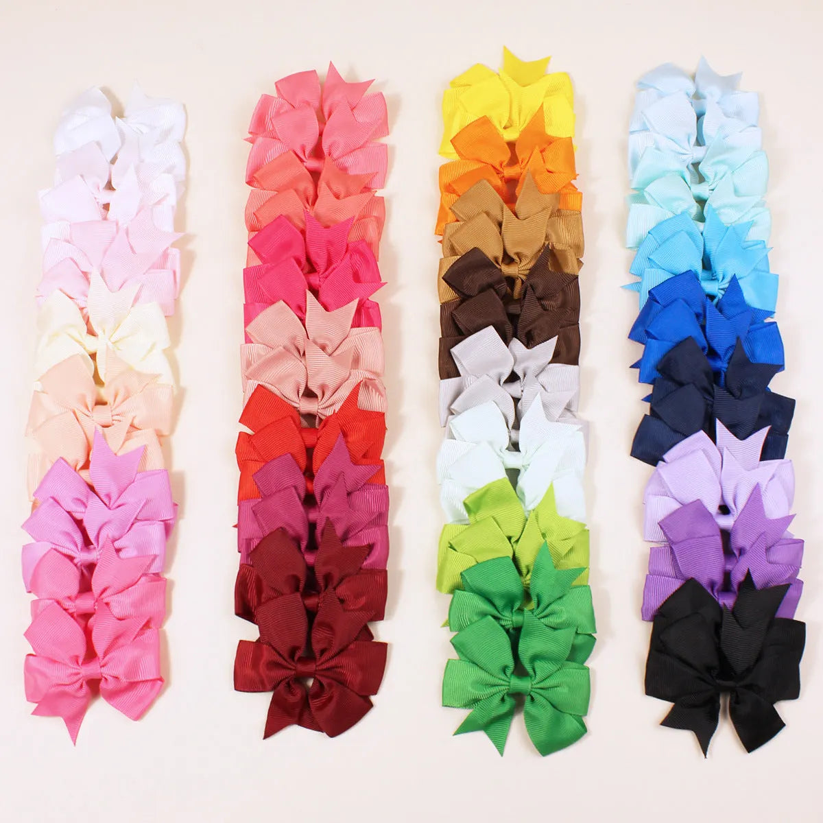 Assorted colourful 3-inch grosgrain ribbon pinwheel hair bows with alligator clips for toddlers.