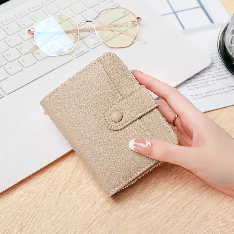 Women's lychee pattern organ short wallet in pu leather available in beige pink black and red colours
