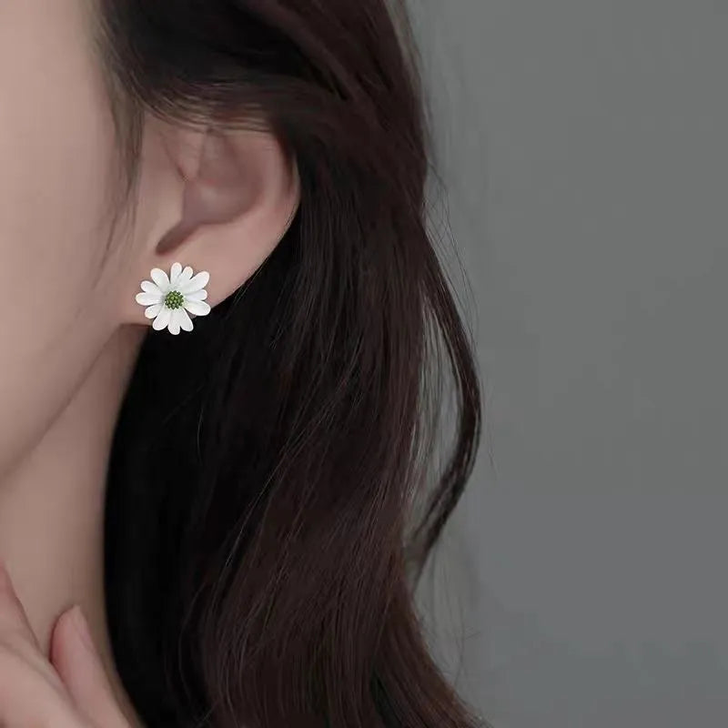 Three pairs of alloy flower earrings in blue-orange, white-green, and yellow-white colour combinations