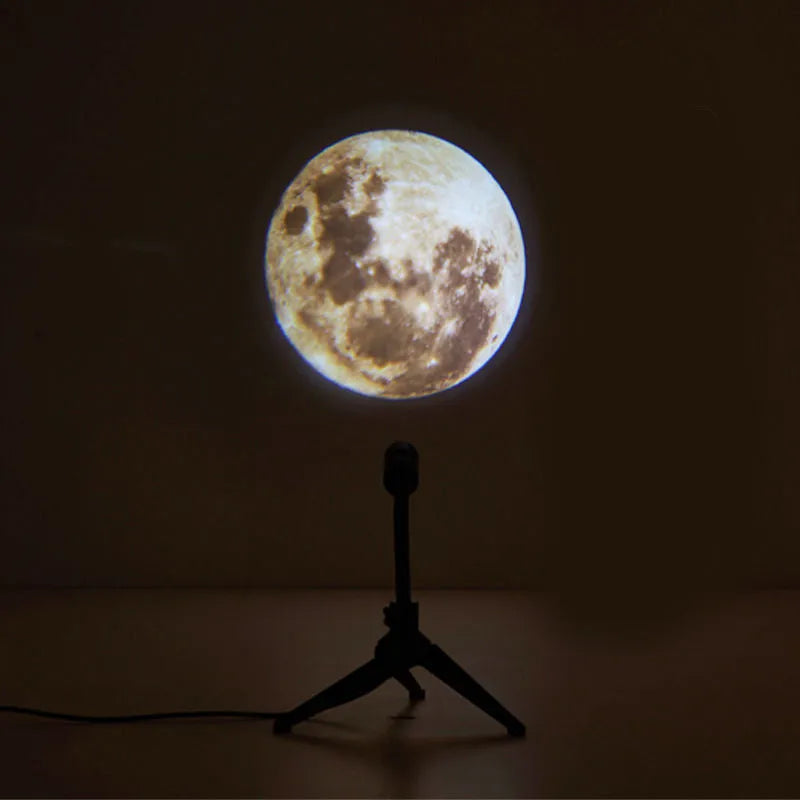 Earth and Moon projection lamp with flexible hose bracket on a table, showing USB cable.